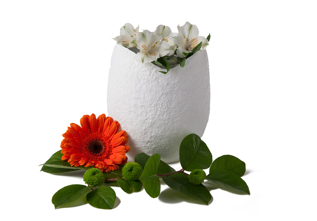 Picture of an ovoid biodegradable cremation urn made of white cotton fibre on sale at Muses Design Urns. Left side view.